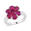 Celebrate the beauty of nature with our Niassa ruby floral ring. This enchanting piece, featuring round-shaped rubies arranged in a stunning floral design and set in platinum over sterling - Sticky add to cart bar