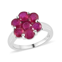 Celebrate the beauty of nature with our Niassa ruby floral ring. This enchanting piece, featuring round-shaped rubies arranged in a stunning floral design and set in platinum over sterling