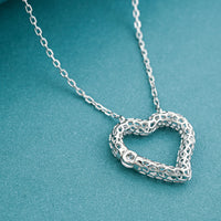 D'Joy Moissanite 0.15 ctw Open Heart Necklace in Rhodium Over Sterling Silver (18 Inches)