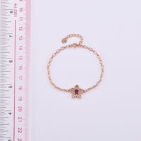 Mozambique Garnet and Simulated Diamond Bracelet in Rosetone (6-7In) 0.30 ctw